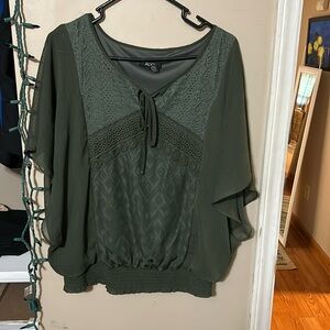 Forest green blouse. Sleeves are sheer and flowy.